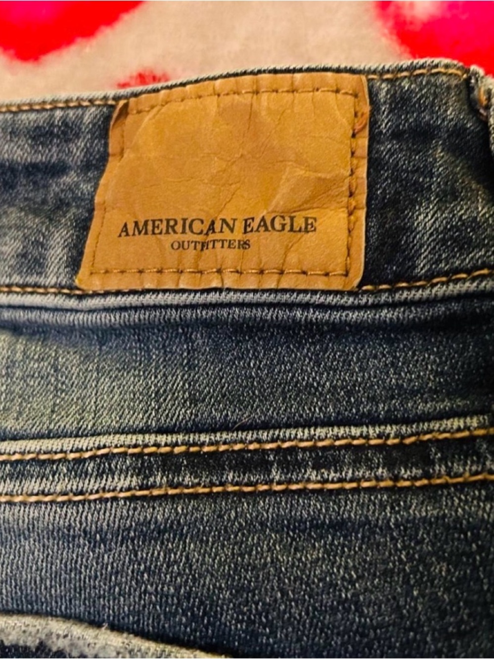 American Eagle Outfitters Dark Blue Denim Jeans with Tan Leather Patch.